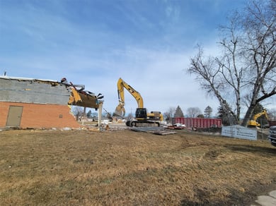 Excavator taking down a building