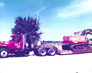 Truck hauling an excavator