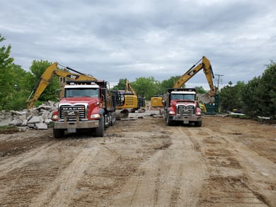 Trucks carrying away debris